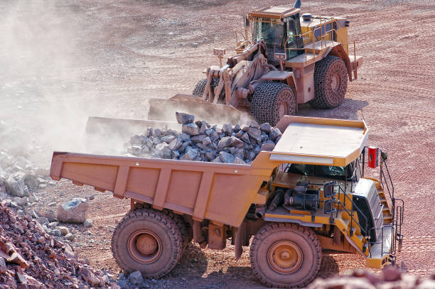 earth mover loading dumper truck with rocks.