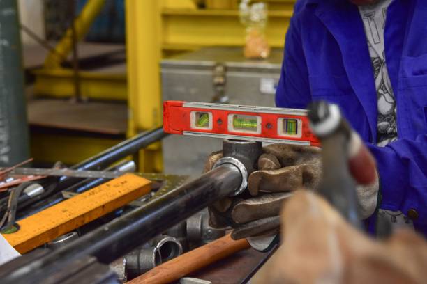 Worker check the level of the pipe in the horizontally with a Water level Meter Indicator.