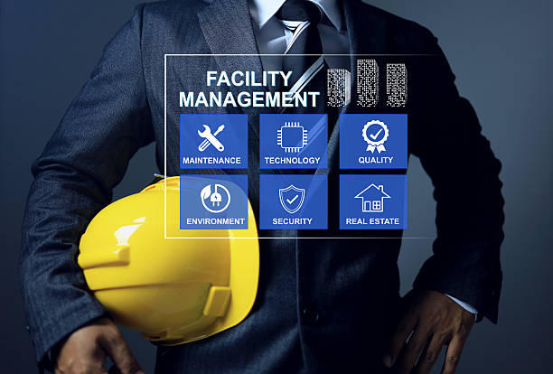 Facility management concept with engineering manager is holding yellow helmet to manage and monitoring facility works infrastructure system in smart city and manufacture plant